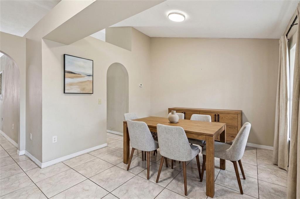42 Inconnu Drive Poinciana, FL 34759 - Photo 7 of 29 a view of a dining room with furniture and wooden floor