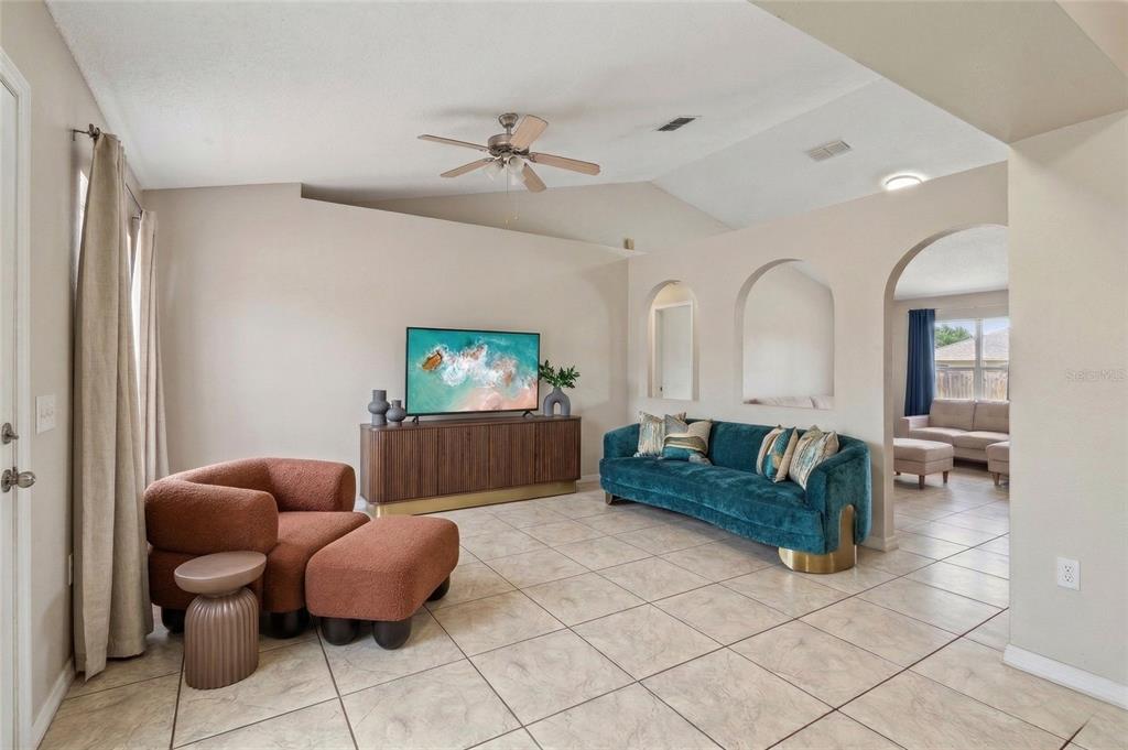 42 Inconnu Drive Poinciana, FL 34759 - Photo 9 of 29 a living room with furniture and a potted plant