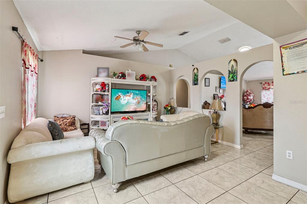 42 Inconnu Drive Poinciana, FL 34759 - Photo 10 of 29 a living room with furniture and a flat screen tv