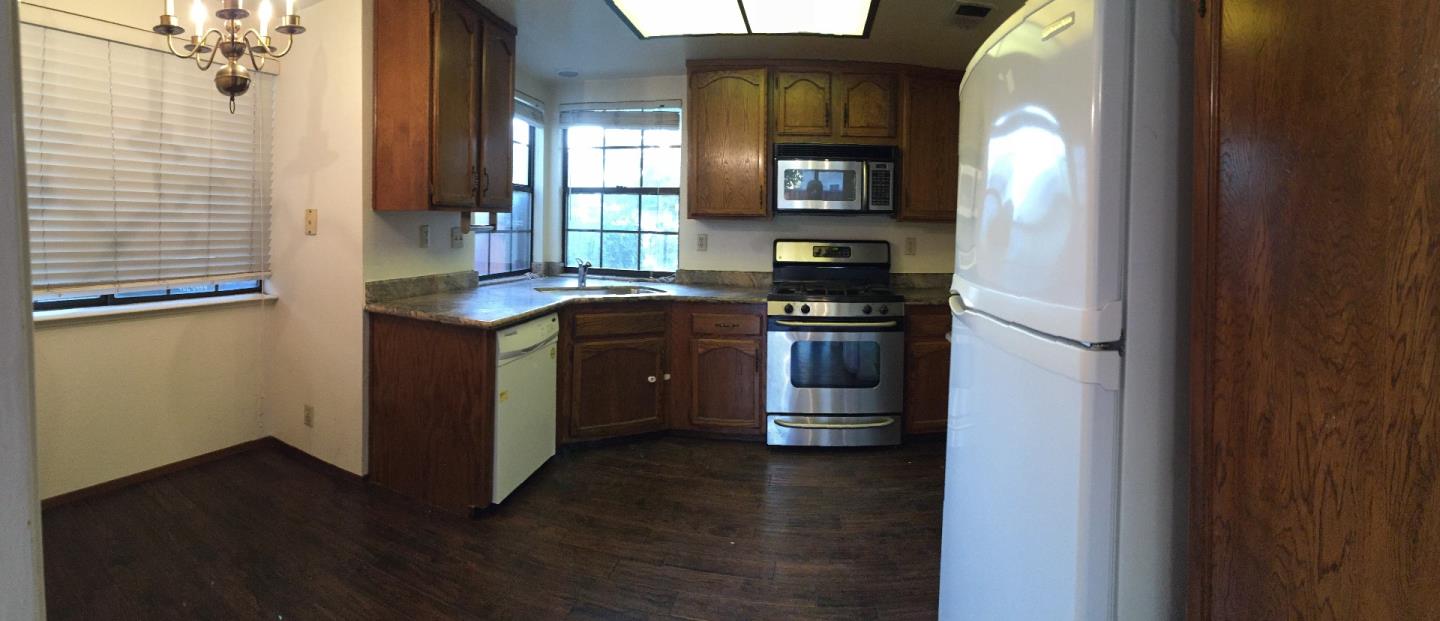 752 Superior Road Milpitas, CA 95035 - Photo 5 of 14 a kitchen with stainless steel appliances granite countertop a sink and a stove next to a window