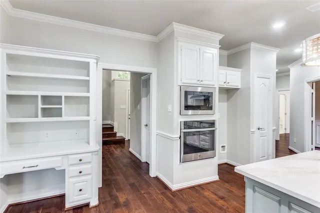 a view of kitchen with furniture and refrigerator