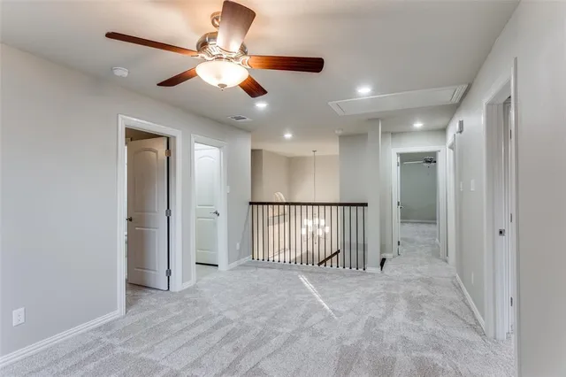 en view of a livingroom with a ceiling fan and window