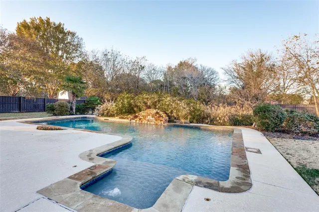 a view of a swimming pool with an outdoor space and seating area