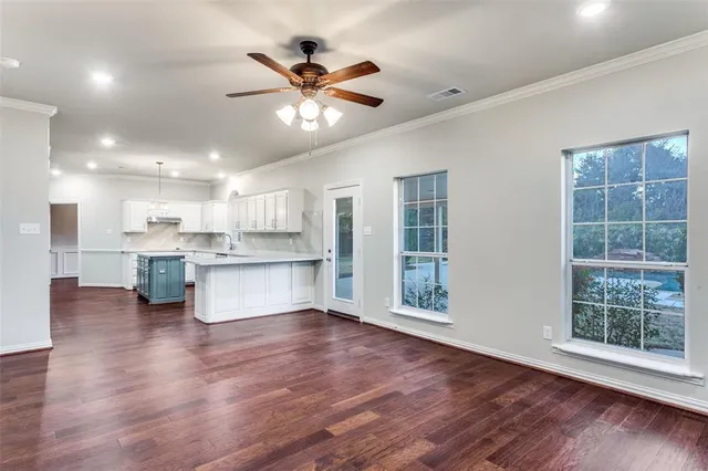 a view of kitchen with granite countertop stainless steel appliances cabinets and a large window