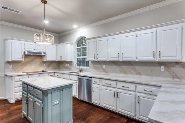 a kitchen with a sink window and cabinets