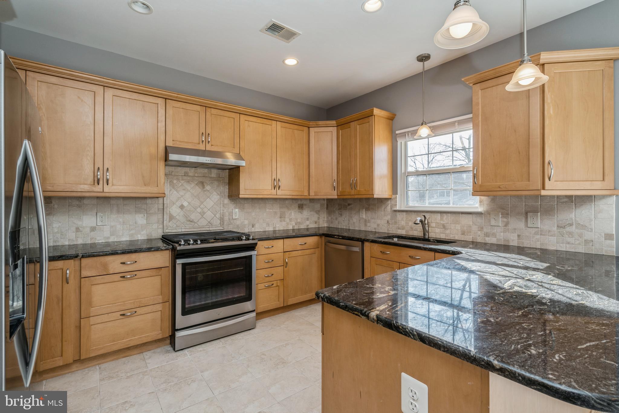 26 Manley Road Pennington, NJ 08534 - Photo 8 of 38 a kitchen with stainless steel appliances granite countertop a sink a stove and a microwave