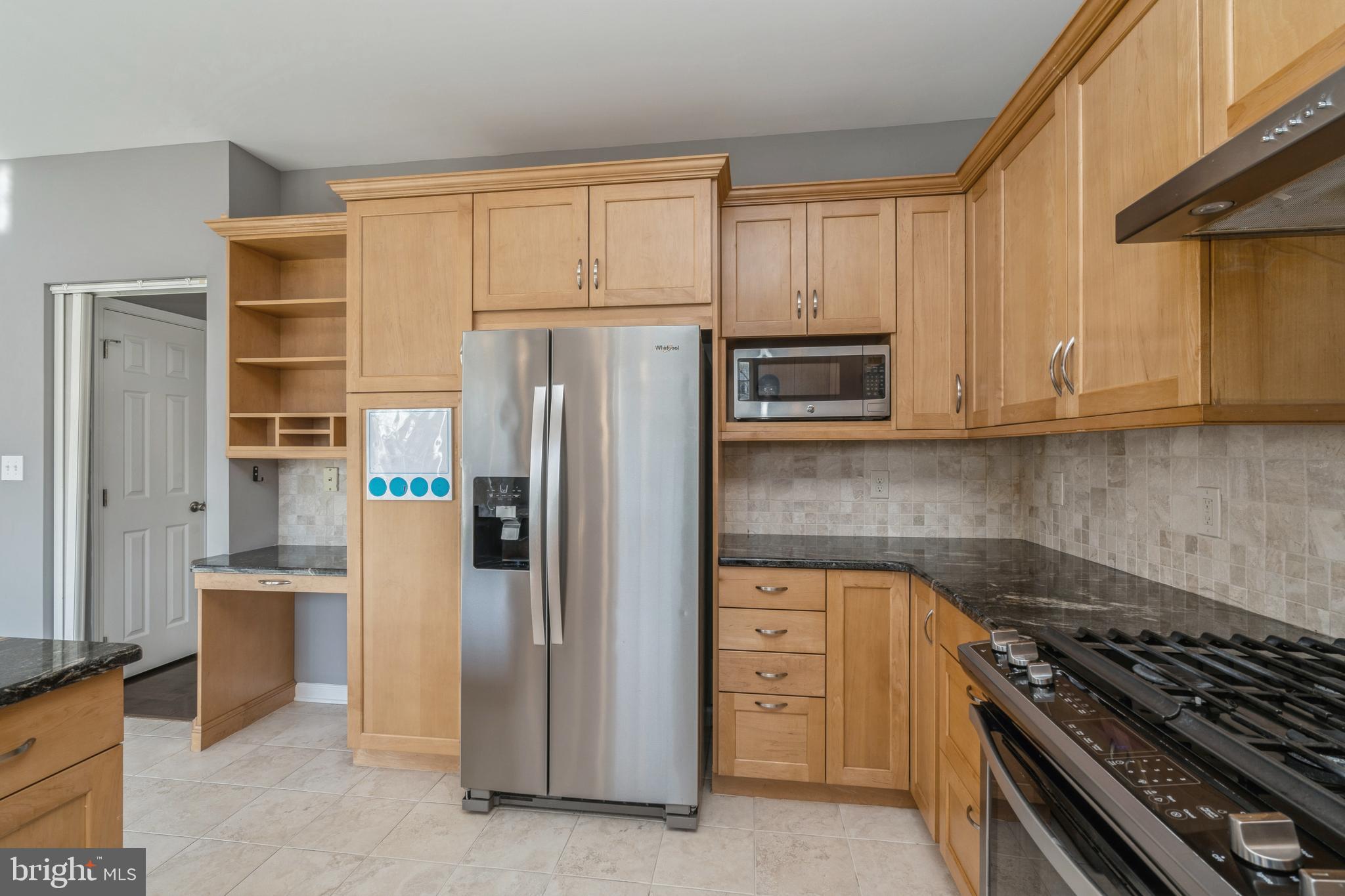 26 Manley Road Pennington, NJ 08534 - Photo 10 of 38 a kitchen with stainless steel appliances granite countertop a refrigerator stove and sink