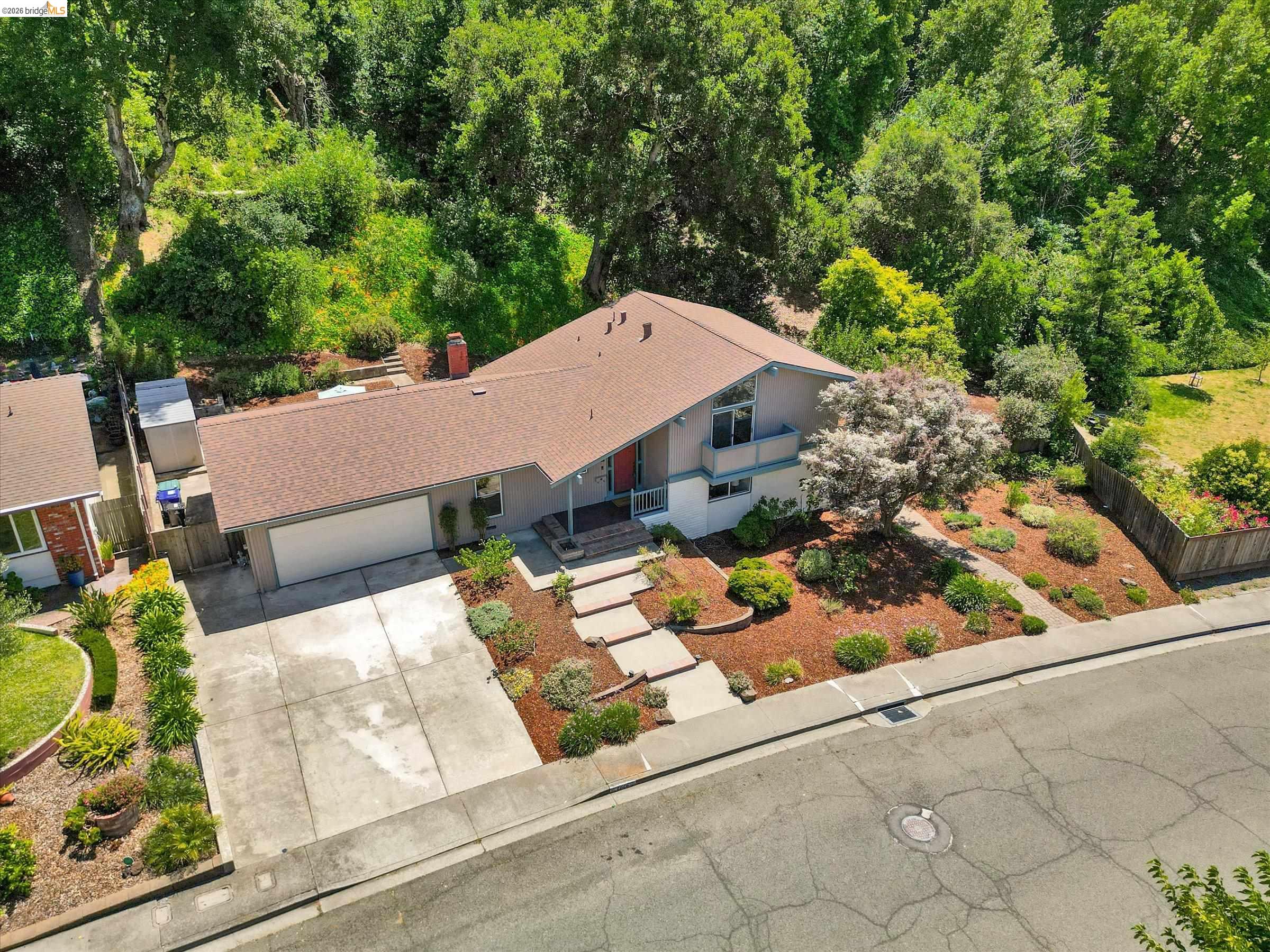 2826 Wright Avenue Pinole, CA 94564 - Photo 58 of 70 Contemporary single-family residence featuring a two-car garage, a terraced front yard with mature landscaping, and a multi-level concrete walkway