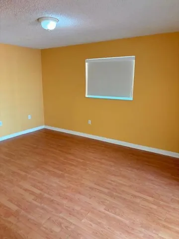 a view of a blue wall with wooden floor