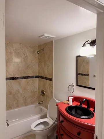 a bathroom with a sink toilet and shower