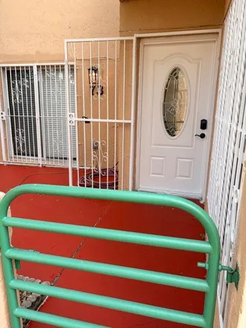 a small white building with a black and white curtain