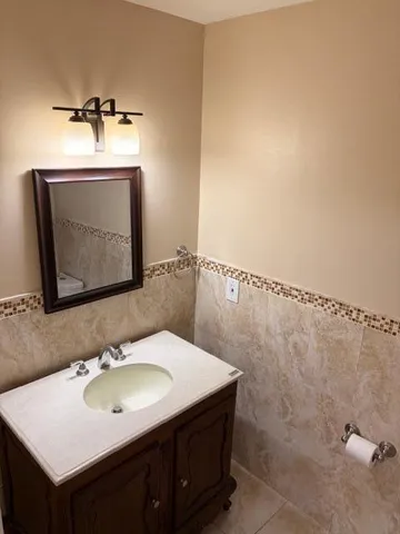 a bathroom with a sink vanity and a mirror