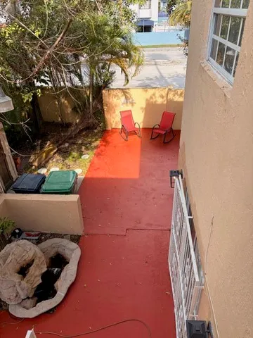 a view of a balcony with wooden floor