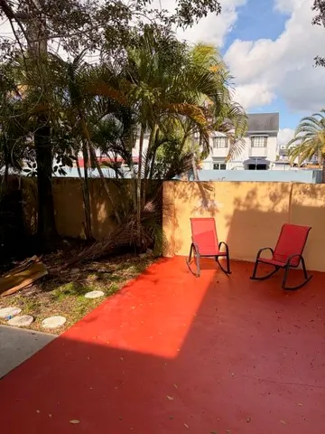 a backyard of a house with yard and outdoor seating