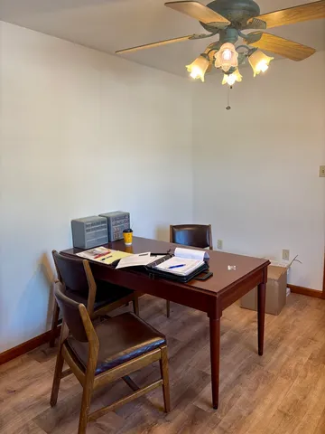 a view of a workspace with a table and a chair