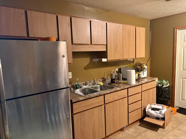 a kitchen with stainless steel appliances granite countertop a refrigerator sink and cabinets