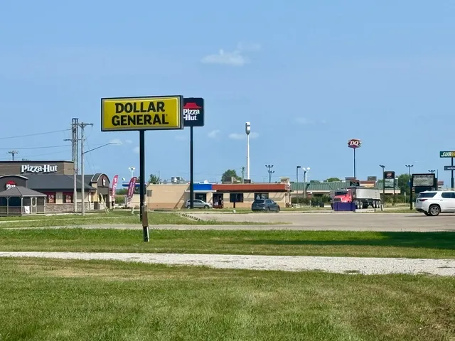 a sign board with a play ground in the back