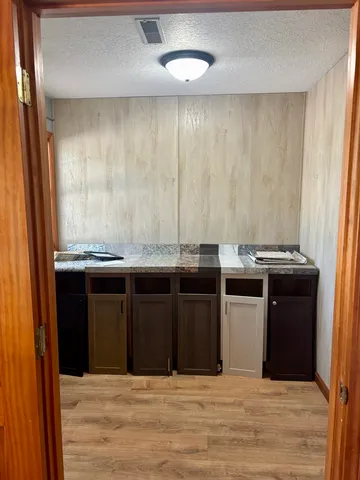 a view of a kitchen with stainless steel appliances granite countertop a stove and a refrigerator