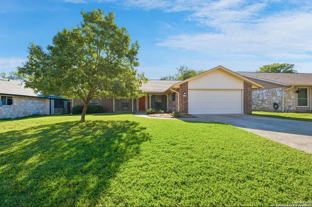 a front view of house with yard and green space