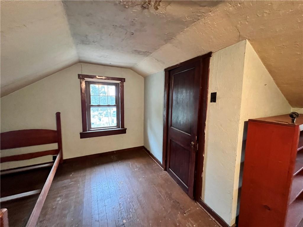 124 Pine Hill Road Kittanning, PA 16201 - Photo 13 of 20 an empty room with wooden floor windows and staircase