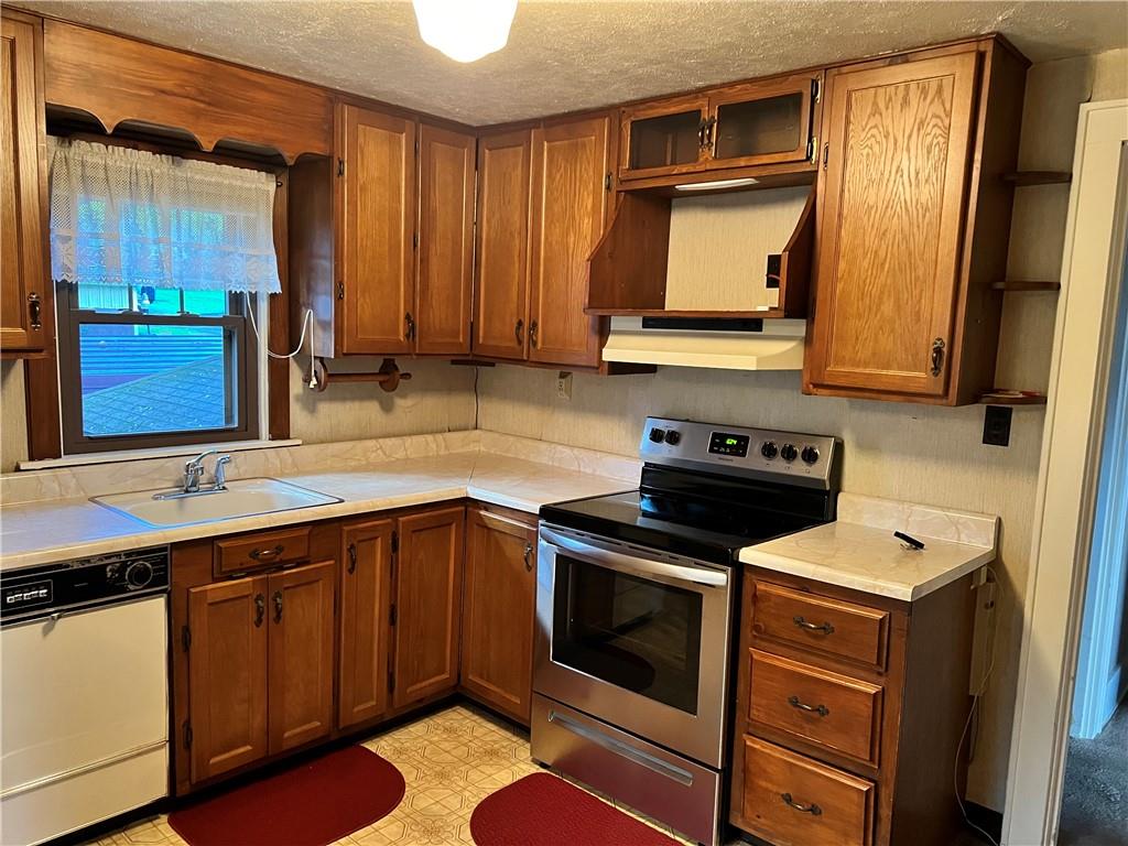 124 Pine Hill Road Kittanning, PA 16201 - Photo 5 of 20 a kitchen with a sink stove and microwave