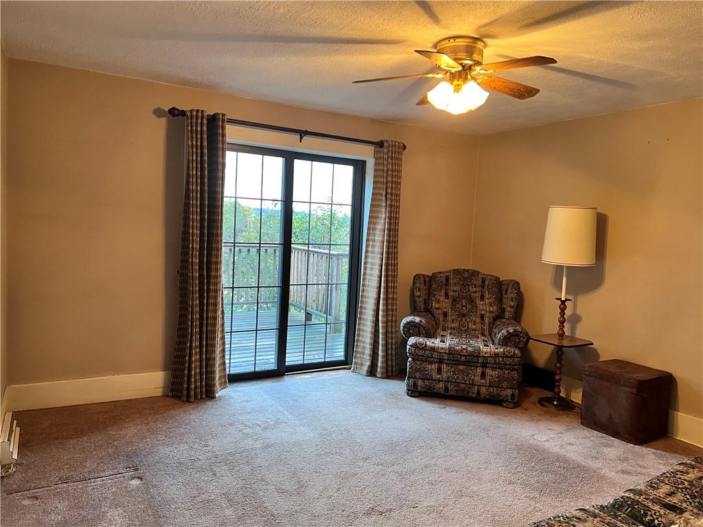 124 Pine Hill Road Kittanning, PA 16201 - Photo 8 of 20 a living room with furniture a ceiling fan and a window