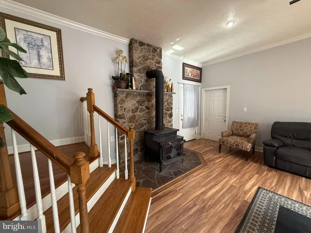 a bedroom with furniture and wooden floor