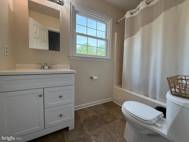 a bathroom with a sink a toilet and tub