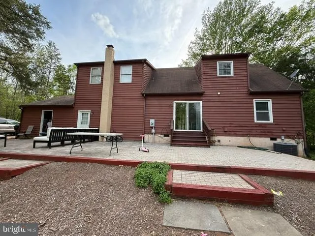 a front view of house with yard outdoor seating and barbeque oven