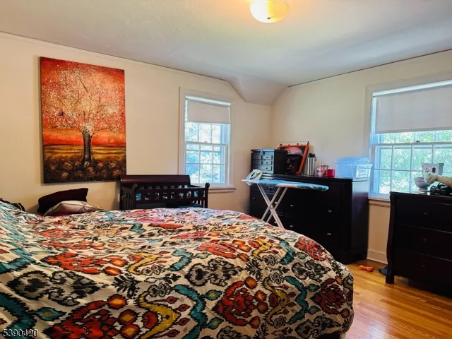 a view of a swimming pool with a big yard and large trees