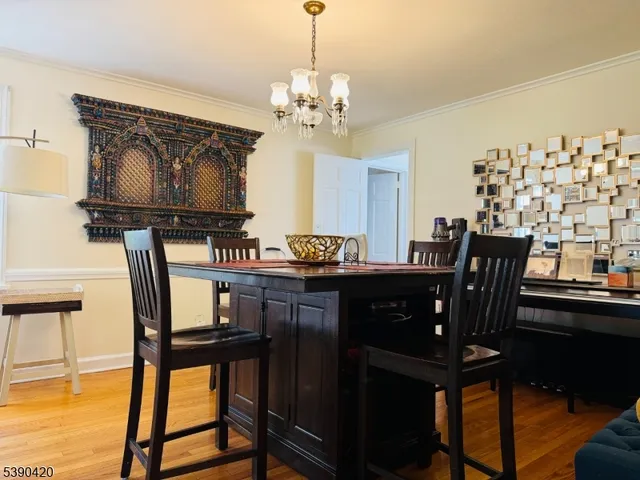 a dining room with furniture and chandelier