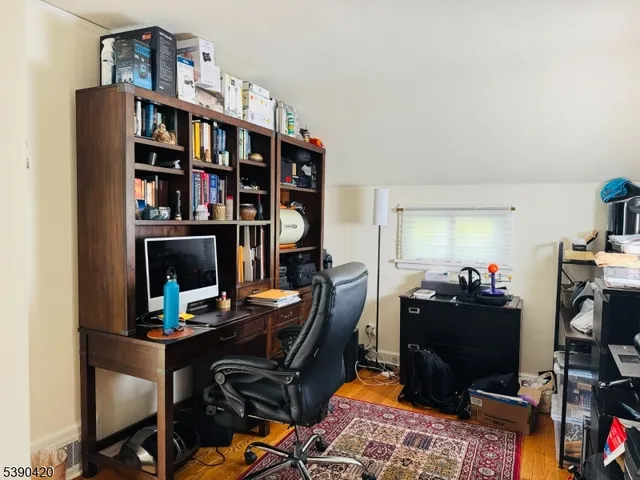 a view of a workspace with furniture and a window