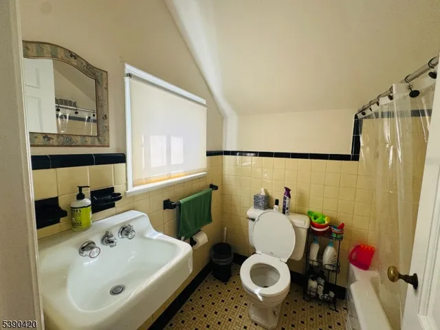 a bathroom with a sink and mirror with toilet