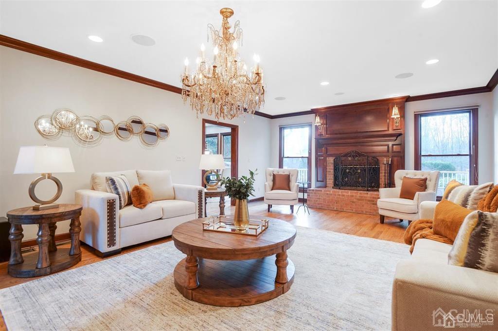 270 Springhill Road Skillman, NJ 08558 - Photo 11 of 27 a living room with furniture a chandelier and a fireplace