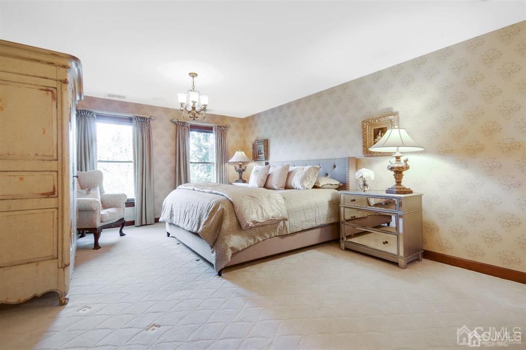270 Springhill Road Skillman, NJ 08558 - Photo 12 of 27 a bedroom with a bed couch and a chandelier