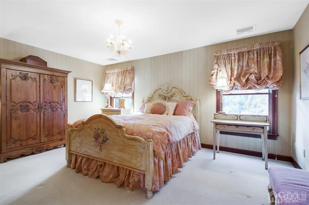 270 Springhill Road Skillman, NJ 08558 - Photo 17 of 27 a bedroom with a bed and a chandelier