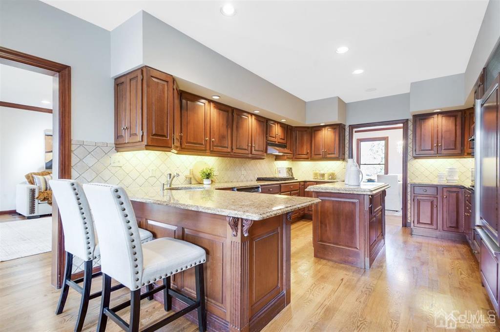 270 Springhill Road Skillman, NJ 08558 - Photo 5 of 27 a kitchen with stainless steel appliances granite countertop wooden cabinets a dining table and chairs