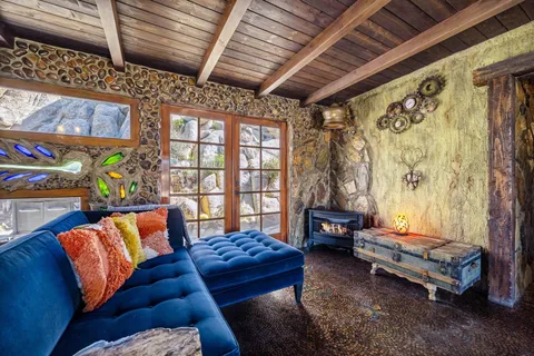 a view of a dining room with furniture a chandelier and wooden floor