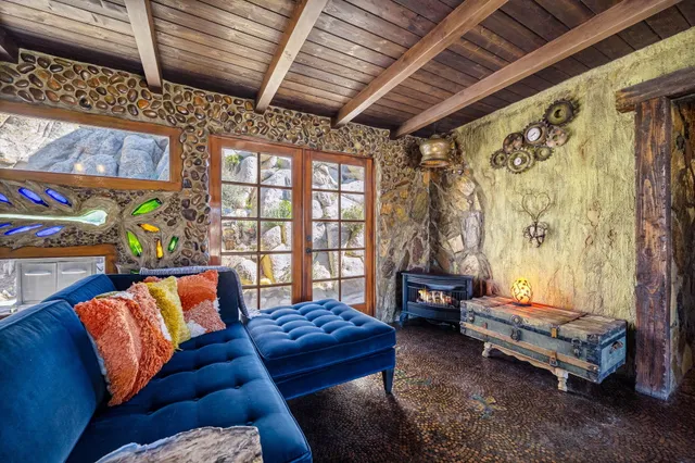 a view of a dining room with furniture a chandelier and wooden floor