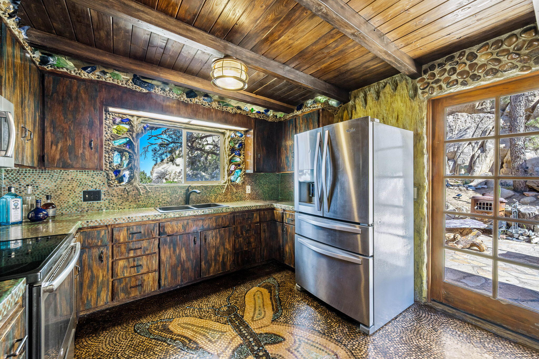 5845 Cholla Avenue Yucca Valley, CA 92284 - Photo 17 of 75 a kitchen with stainless steel appliances granite countertop a refrigerator and a wooden cabinets