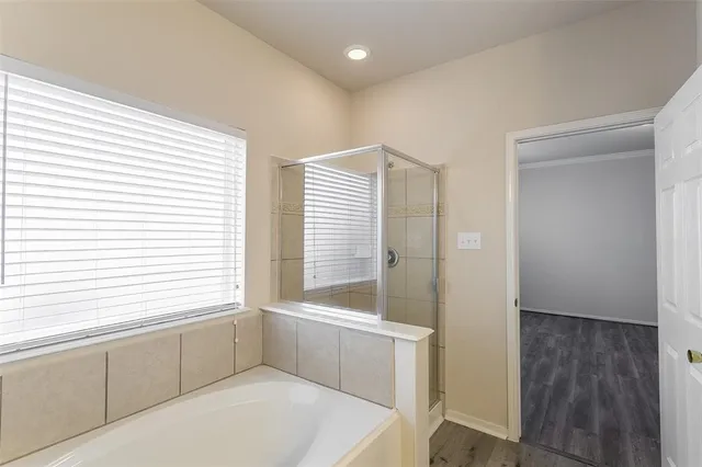 a bathroom with a bathtub and shower