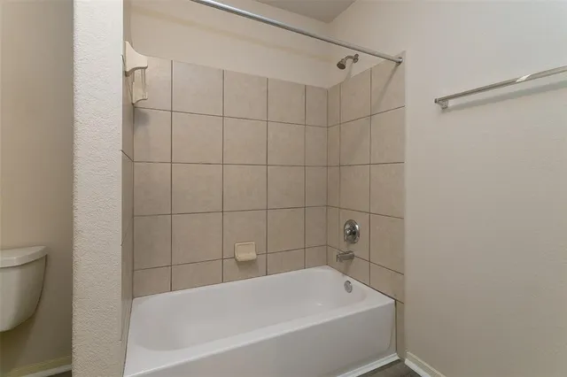 a bathroom with a bathtub and a toilet
