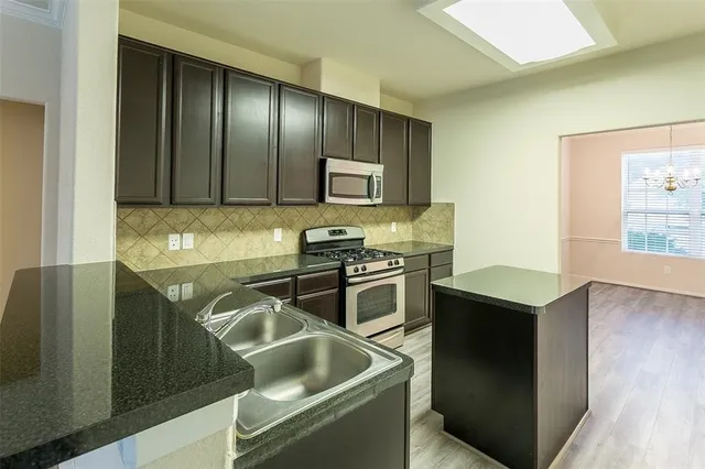 a kitchen with a stove and a refrigerator