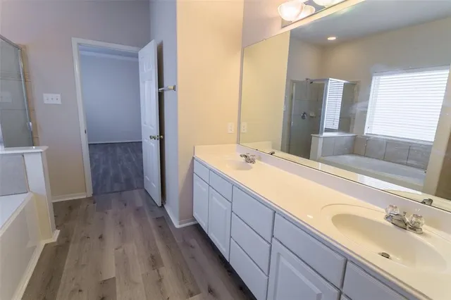 a spacious bathroom with a double vanity sink and mirror