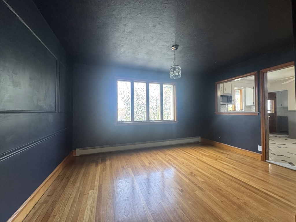 53 Breck Avenue Boston, MA 02135 - Photo 13 of 35 a view of an empty room with wooden floor and a window