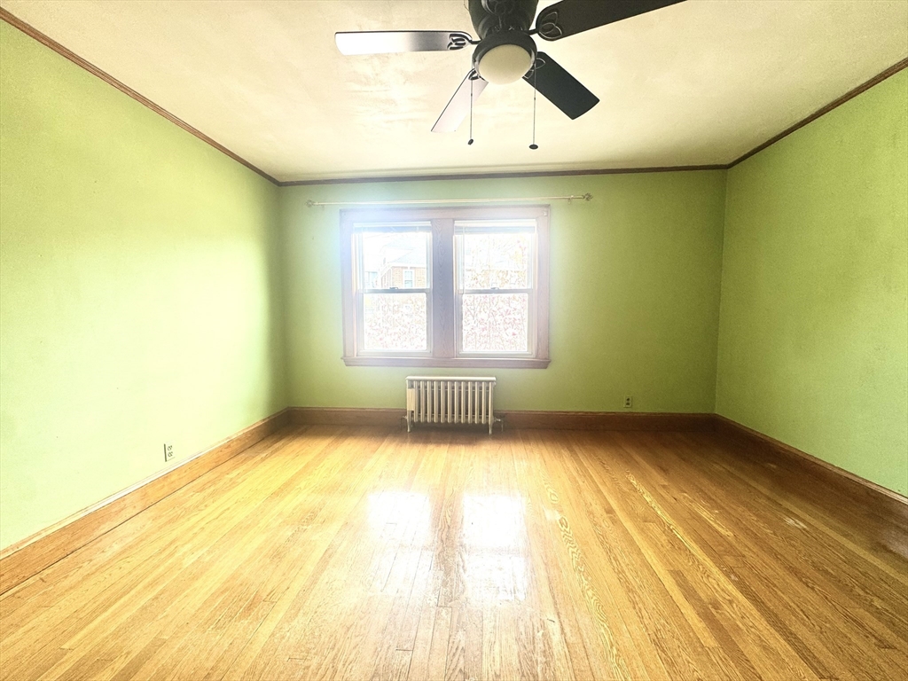 53 Breck Avenue Boston, MA 02135 - Photo 16 of 35 a view of a bedroom with wooden floor and windows