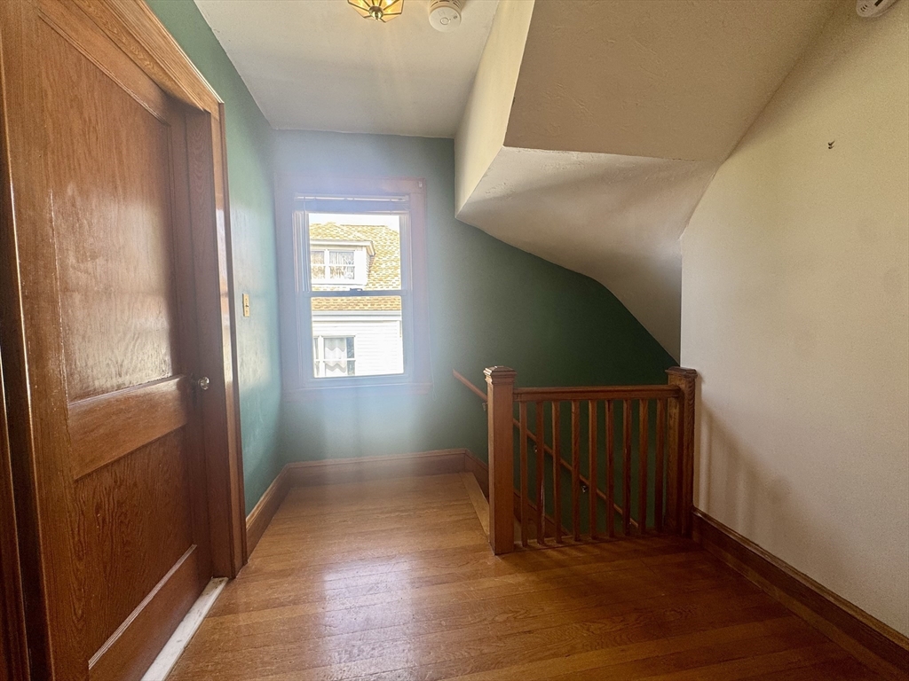 53 Breck Avenue Boston, MA 02135 - Photo 20 of 35 a view of a hallway with wooden floor