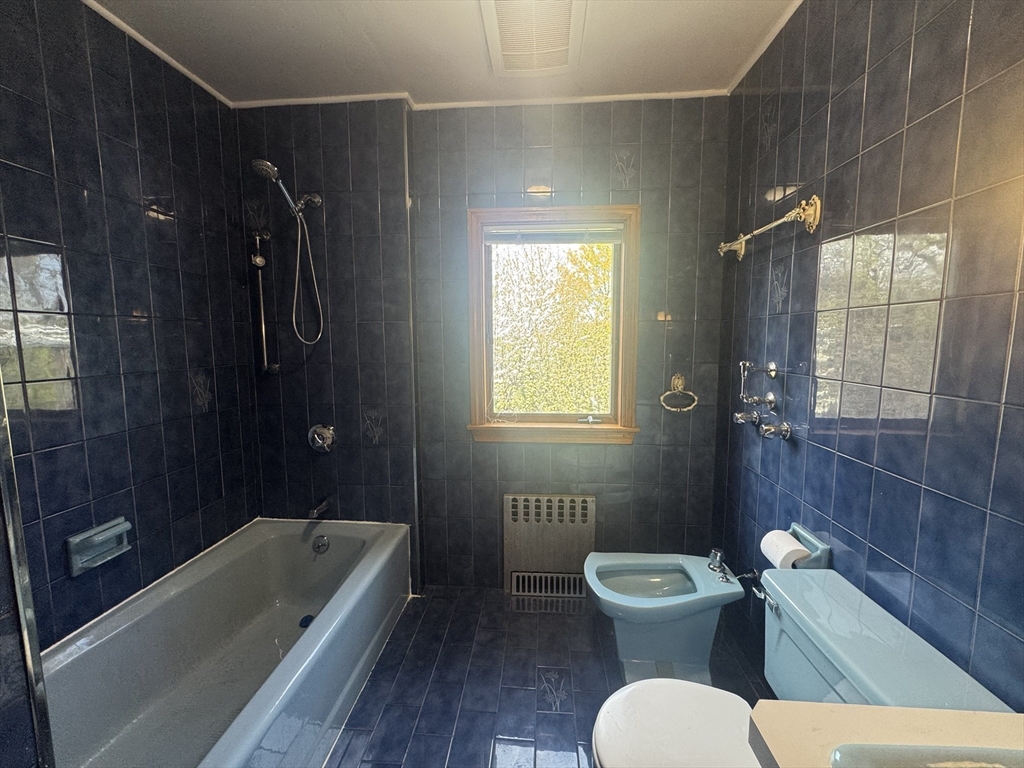 53 Breck Avenue Boston, MA 02135 - Photo 24 of 35 a bathroom with a toilet a sink and bathtub