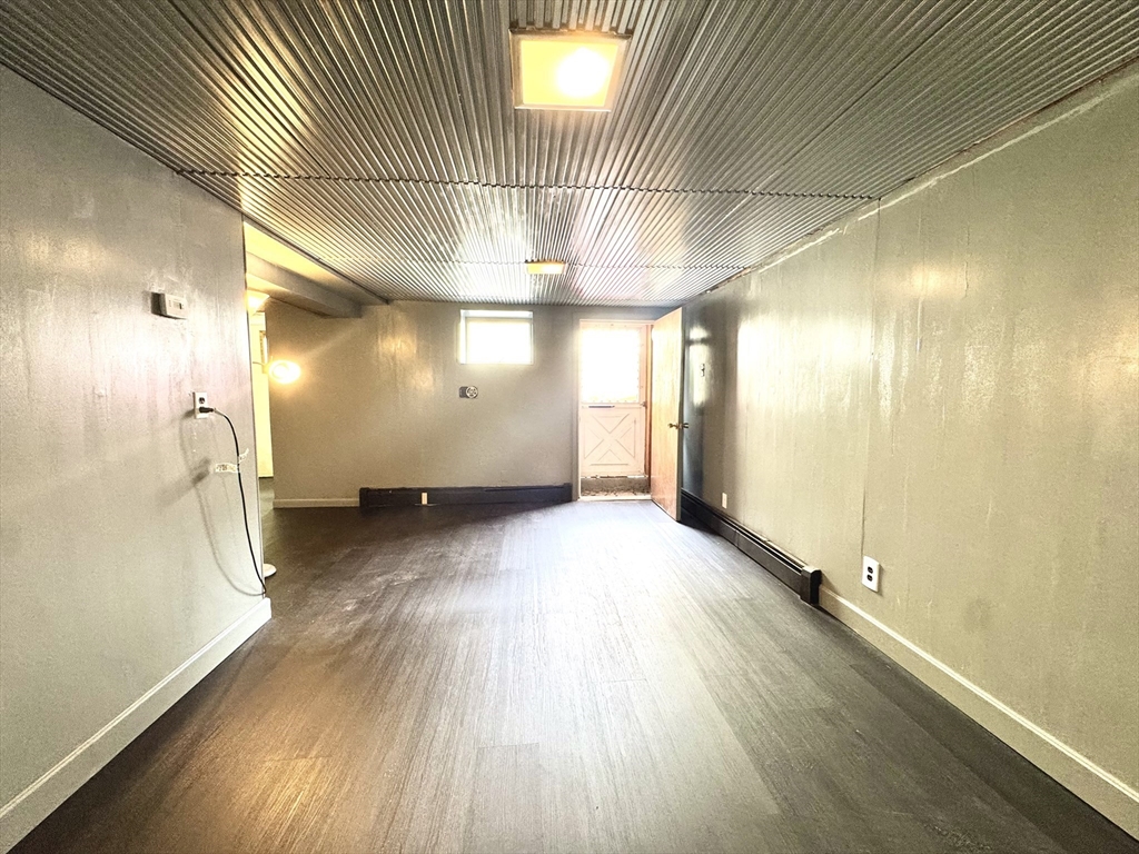 53 Breck Avenue Boston, MA 02135 - Photo 28 of 35 a view of a room with wooden floor