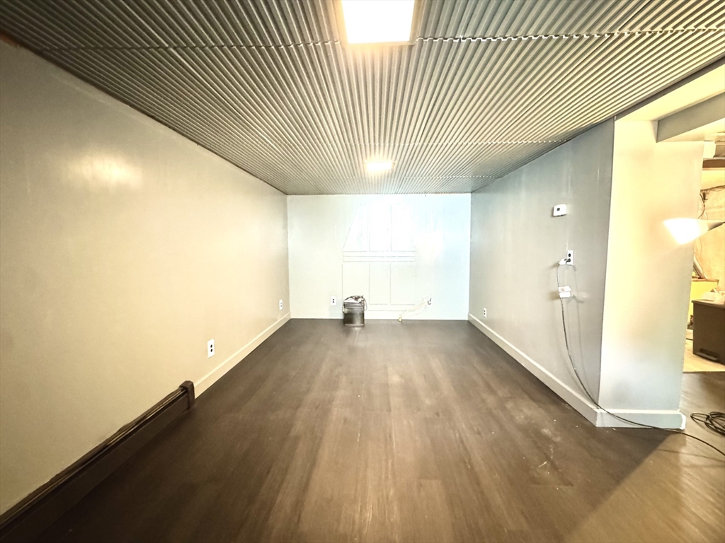 53 Breck Avenue Boston, MA 02135 - Photo 29 of 35 a view of a room with wooden floor